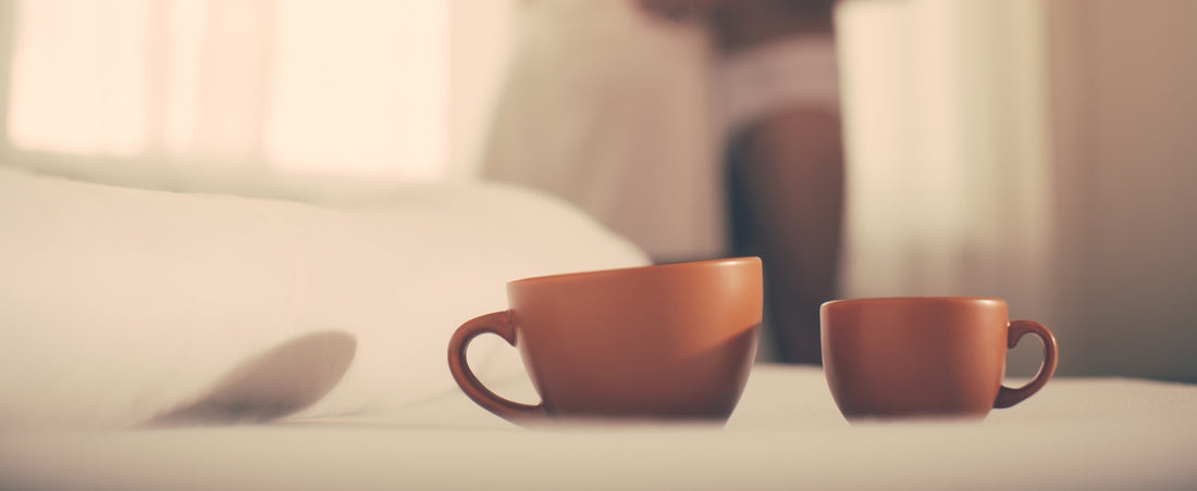 two coffee cups on bed - coffee and sex drive
