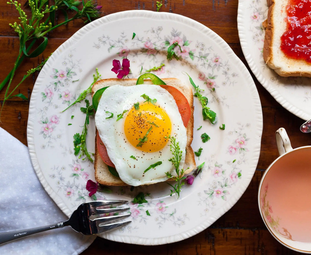 open-faced egg breakfast sandwich on plate