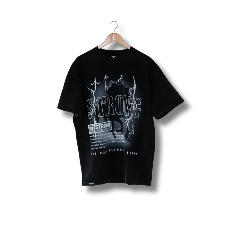 A black t-shirt with white text and graphic design hanging on a hanger against a black background.