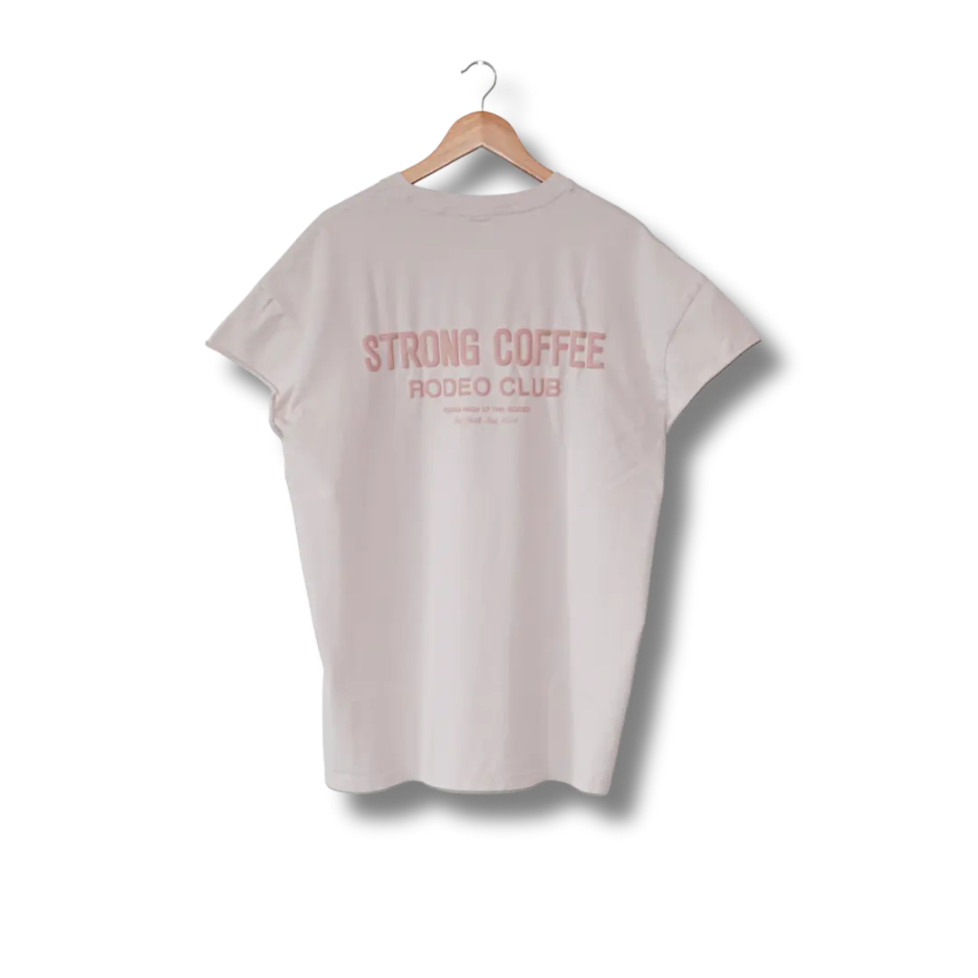 A sleeveless white t-shirt with text 'STRONG COFFEE RODEO CLUB' printed on the back, displayed on a hanger.
