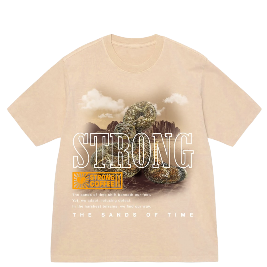 A beige t-shirt with a graphic print of a rattlesnake and the words 'STRONG' and 'THE SANDS OF TIME'.